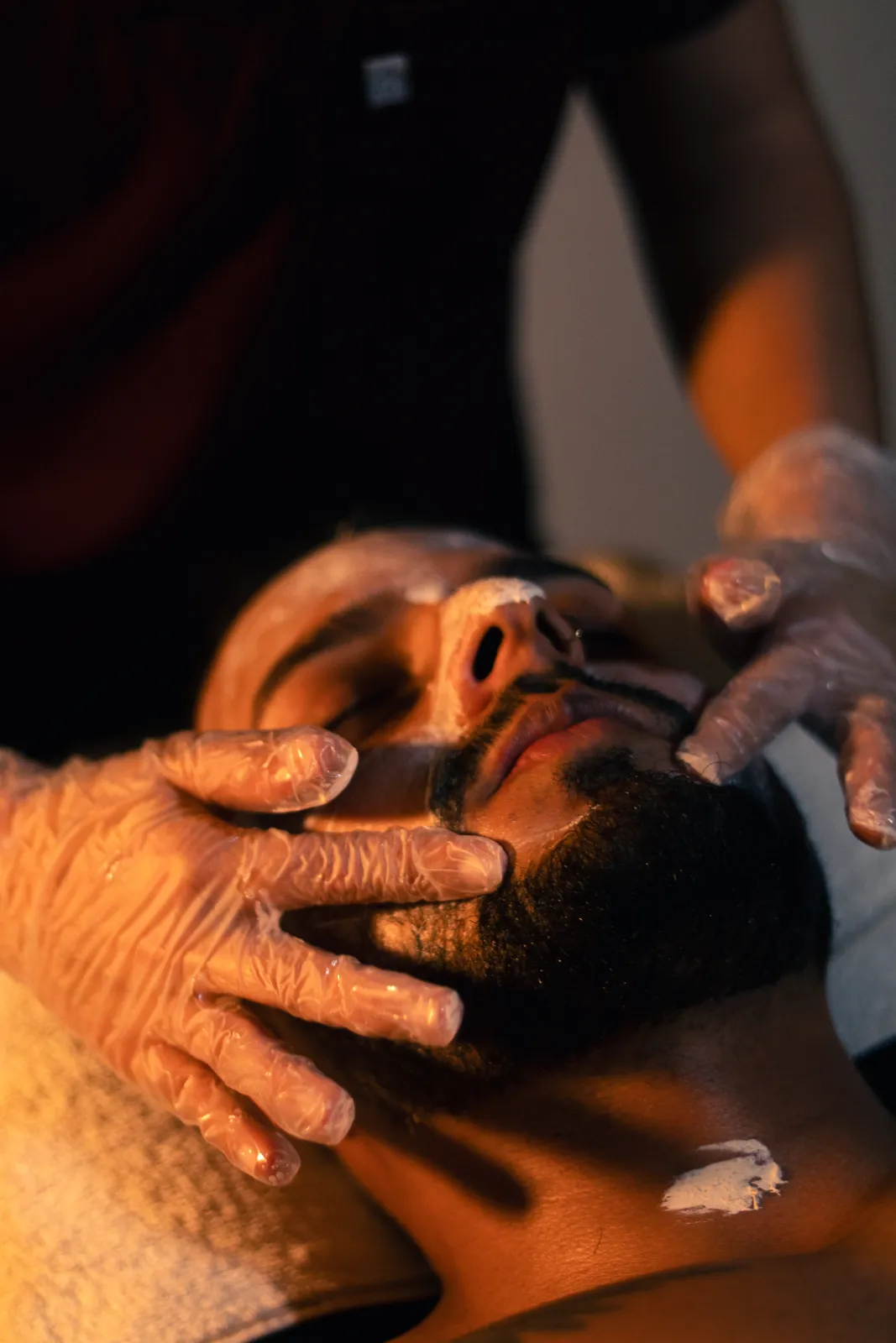 Man receiving a facial treatment